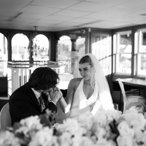 Bride and groom in a romantic setting with flowers.