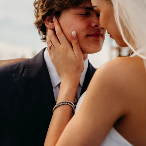 Bride and groom sharing an intimate moment outdoors.