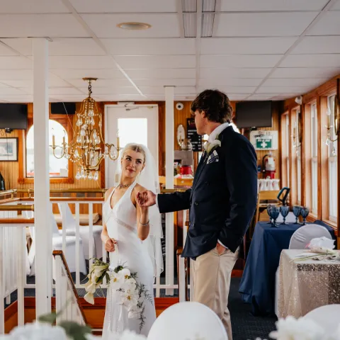 Bride and groom on a decorated boat interior.