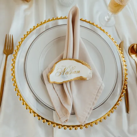 Elegant table setting with gold accents and personalized name card.